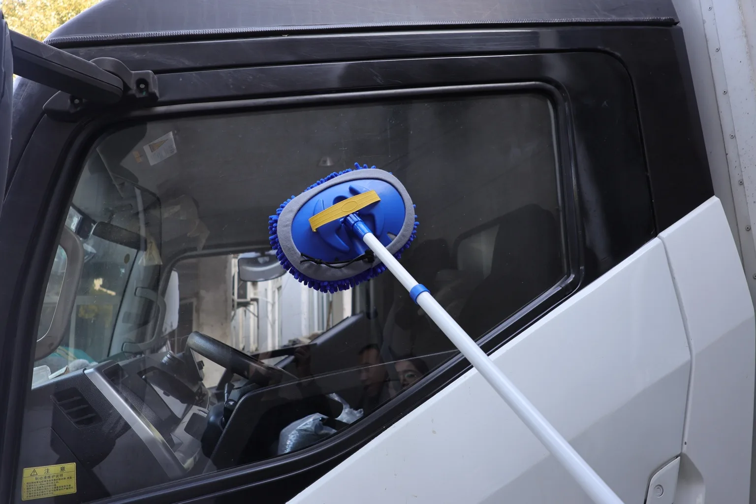 Professional cleaning tool being used on a vehicle window