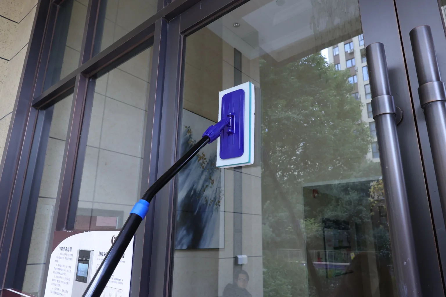 Window cleaning tool in use on glass